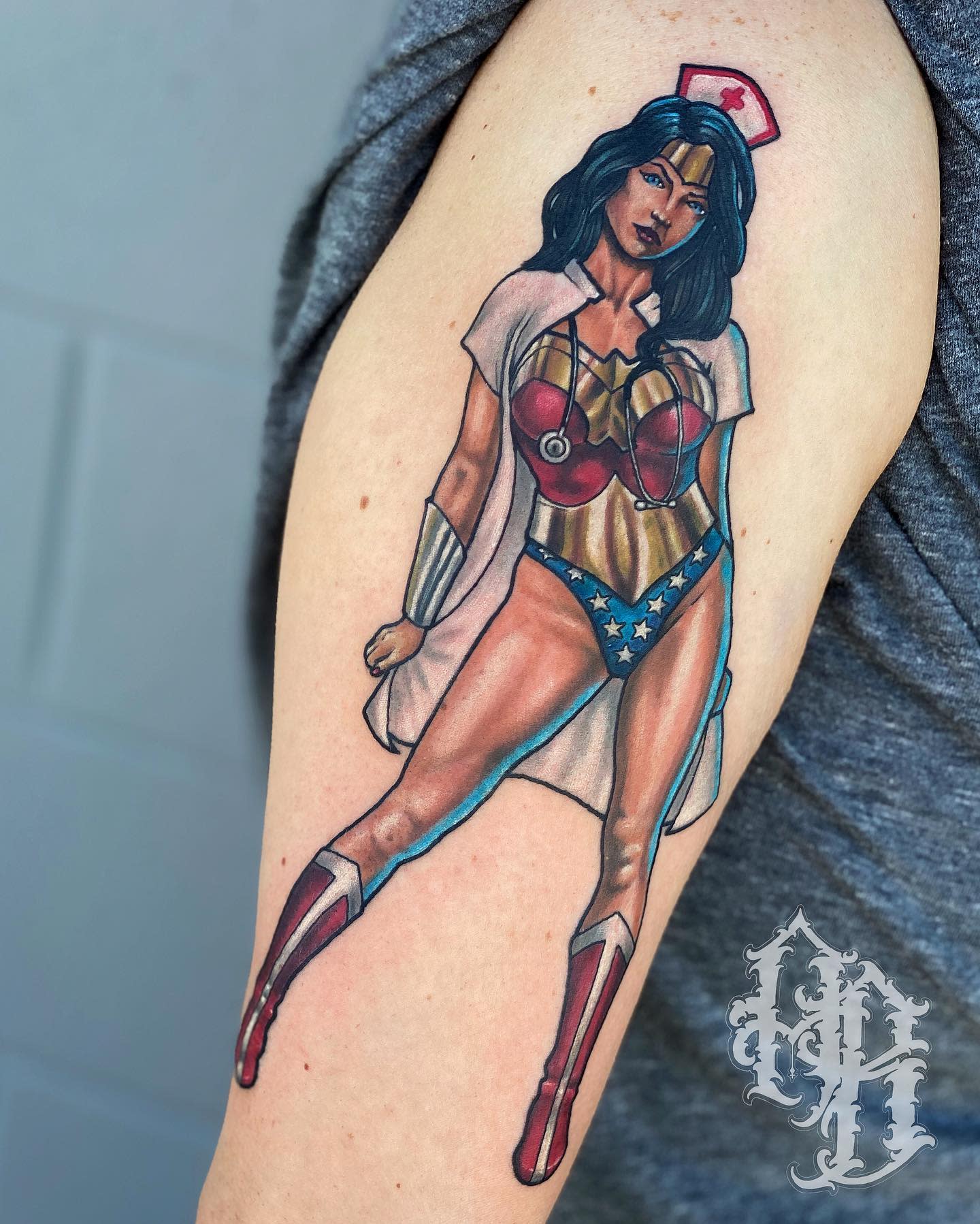 Pin-up style Wonder Woman tattoo wearing a nurse cap and stethoscope, merging heroism with healthcare